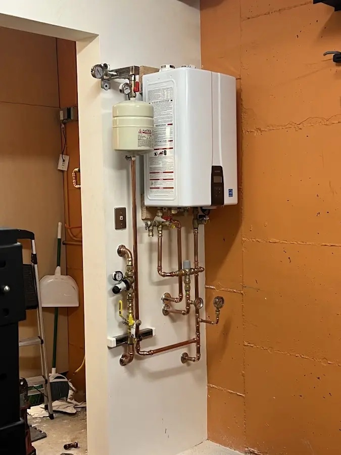 Plumbing technician inspecting water heater connections in Squaw Valley